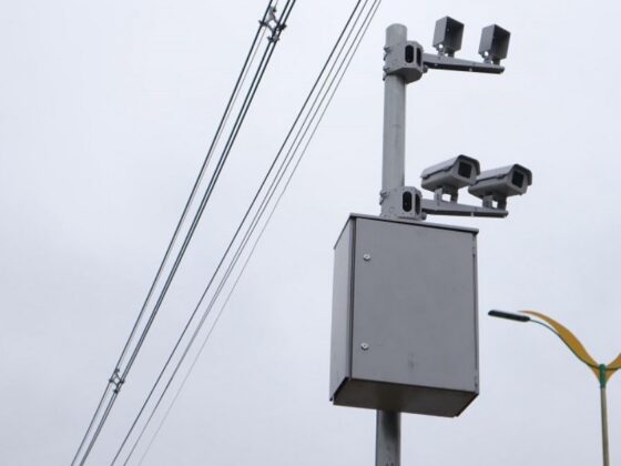 Poste com radares em BH instalado em via urbana, sob céu nublado
