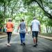 Fitness instructor walking with senior couple at public park