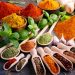 Variety of spices and herbs on kitchen table.