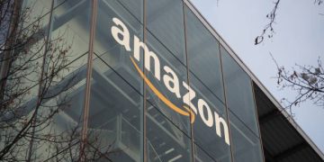 Munich, Bavaria Germany - December 11 2022: Amazon Deutschland Services GmbH e-commerce german headquarters office building with glass green trademark logo. Ultra HD