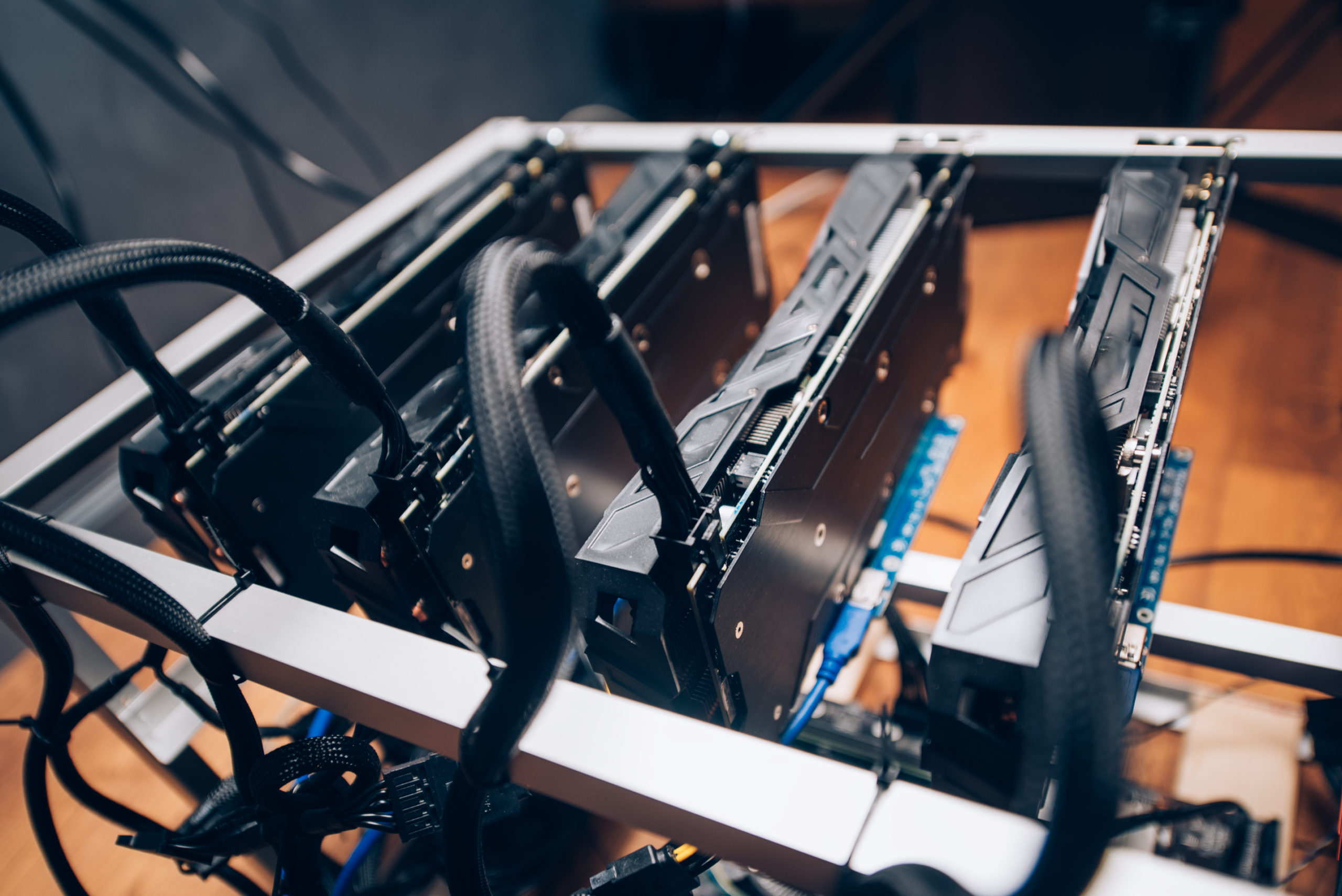 Close up details of mining rig, crypto currency modern technology. Power cables going into gpu graphics cards