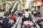 Pessoas sentadas em mesas de restaurante