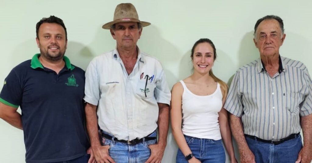 Imagem mostra três homens e uma mulher em pose para foto institucional