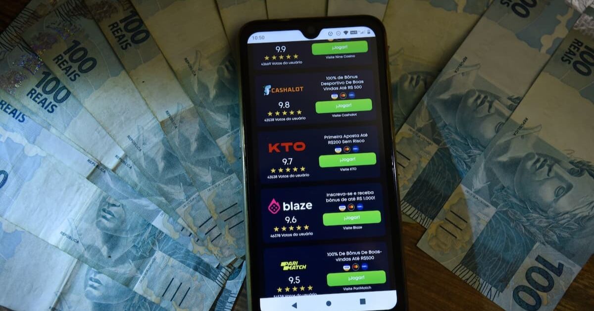 Celular aberto em bets e notas de R$ 100